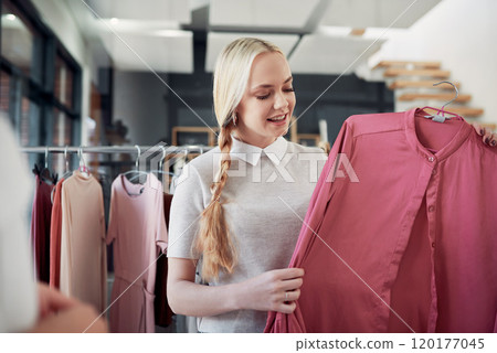I love this fabric. Shot of a young woman shopping for clothes in a store. I love this fabric. Shot of a young woman shopping for clothes in a store. 120177045