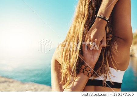 Hold on to whats important to you. Rearview shot of a young woman practicing yoga on the beach. Hold on to whats important to you. Rearview shot of a young woman practicing yoga on the beach. 120177160