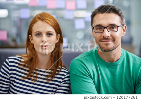 Were ready for our next assignment. Two work colleagues sitting together in the office. Were ready for our next assignment. Two work colleagues sitting together in the office. 120177261