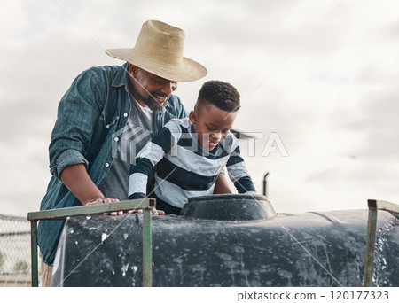 You dont need an amusement park to have an awesome ride. Shot of a mature man helping his adorable son ride a tractor on a farm. 120177323