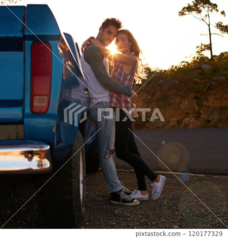 Treating ourselves to a romantic road trip. Shot of an affectionate young couple on a roadtrip. Treating ourselves to a romantic road trip. Shot of an affectionate young couple on a roadtrip. 120177329