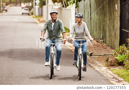 This was a good idea. Shot of a cheerful senior couple riding on bicycles together outside in a suburb. This was a good idea. Shot of a cheerful senior couple riding on bicycles together outside in a suburb. 120177355