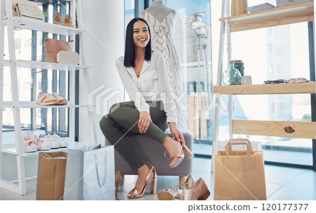 A girl can never have too much shoes. Shot of an attractive young woman fitting on shoes in a boutique. A girl can never have too much shoes. Shot of an attractive young woman fitting on shoes in a boutique. 120177377
