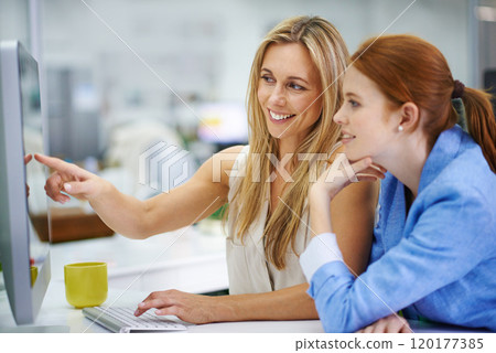See thats where you went wrong. Two attractive female coworkers going over some work on their computer. 120177385