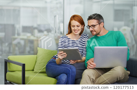 This is great. Two colleagues working together in the office. 120177513