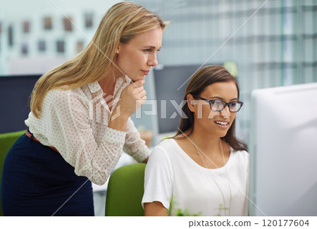 There are no stupid questions. Shot of two attractive female colleagues in a quandary over some work on a computer in an office setting. 120177604