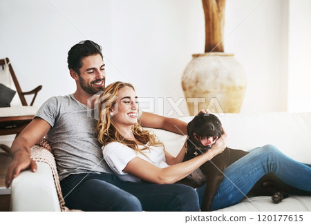 Our family. Shot of a couple and their pet relaxing at home. 120177615