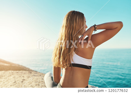 Be out there. Rearview shot of a young woman practicing yoga on the beach. Be out there. Rearview shot of a young woman practicing yoga on the beach. 120177632