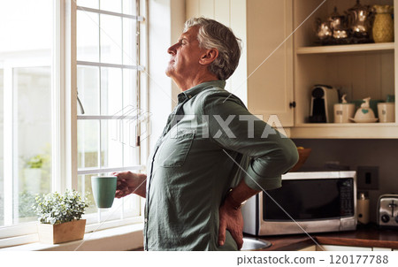 Cant wait to get rid of this back pain. Cropped shot of a relaxed senior man preparing a cup of tea with CBD oil inside of it at home during the day. Cant wait to get rid of this back pain. Cropped shot of a relaxed senior man preparing a cup of tea with CBD oil inside of it at home during the day. 120177788