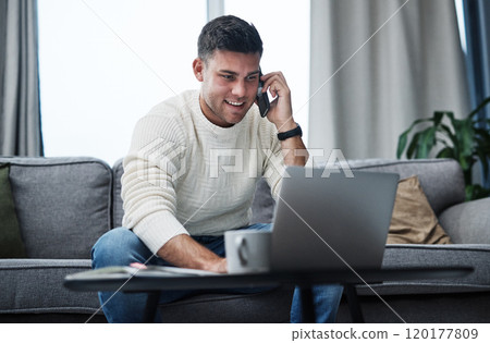 Hire yourself and make it happen. Shot of a young man using a laptop and smartphone while working from home. 120177809