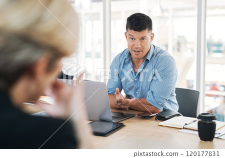Time to talk things out. Shot of a mature businessman and businesswoman having a meeting in a modern office. 120177831