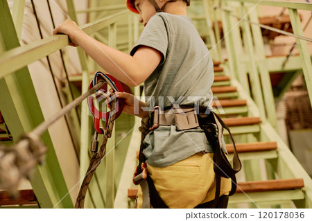 Child moving along hanging bridge Child moving along hanging bridge 120178036