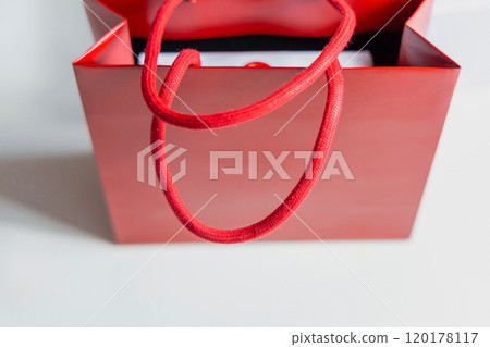 Luxury gift in a box in a red gift bag 120178117