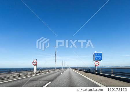 Highway road to Denmark with a sign about crossing the border of Denmark. 120178153