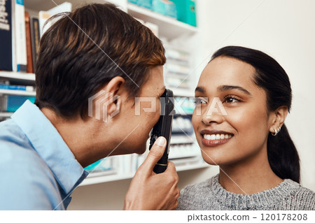 Your eyes look perfectly healthy to me. Shot of a young woman getting her eyes examined by an optometrist. Your eyes look perfectly healthy to me. Shot of a young woman getting her eyes examined by an optometrist. 120178208