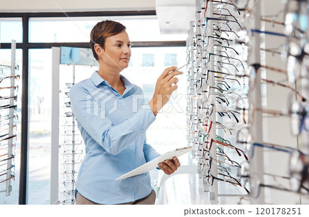 Stocking up on the brands her customers love. Portrait of a confident young woman working in an optometrists office. Stocking up on the brands her customers love. Portrait of a confident young woman working in an optometrists office. 120178251