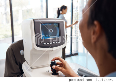 Cutting edge tech for cutting edge eye care. Shot of an optometrist using an autorefractor during an eye exam. 120178269