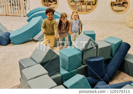 Happy kids on playground with soft cubes Happy kids on playground with soft cubes 120178313