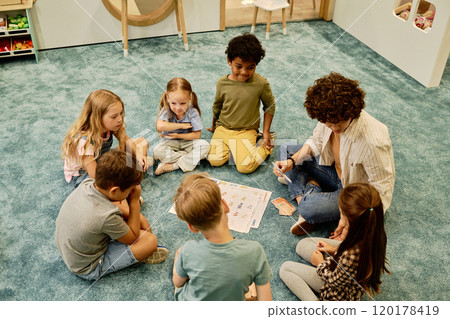 Teacher talking to little girl at lesson 120178419