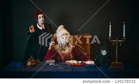 Elderly woman, royal person, countess in period attire sitting at table and smoking, young man, court servant standing near. 120178532