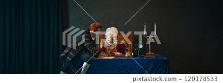 Elderly woman with bright makeup and wig, empress sitting at table and talking to court servant writing a letter. Royal lifestyle. Banner Elderly woman with bright makeup and wig, empress sitting at table and talking to court servant writing a letter. Royal lifestyle. Banner 120178533