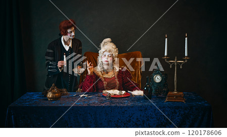 Royal empress, elderly woman with impressive makeup, wearing baroque gown and wig, holding cigarette and her loyal favorite standing beside with candle. 120178606