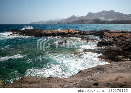 Rocky cliffs at Naxos Hora town in Naxos, largest of the Greek Cyclades islands in the Aegean sea, Greece 120179185