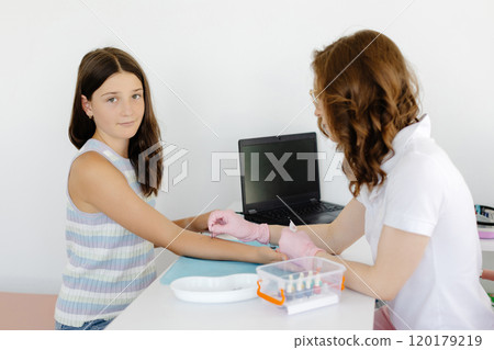 Doctor doing skin allergy test at white table in office. Allergy test - skin prick allergy testing for possible allergens Doctor doing skin allergy test at white table in office. Allergy test - skin prick allergy testing for possible allergens 120179219