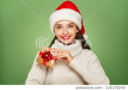Beautiful woman in a white knitted sweater with gift box 120179249