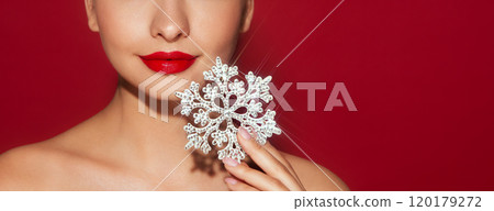 Beautiful young woman with glowing snowflake 120179272