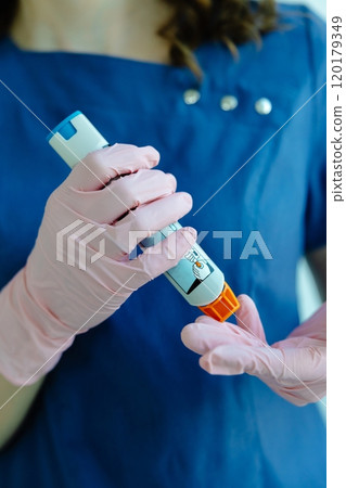 Doctor is demonstrating auto-injector syringe as an emergency treatment for allergic reaction Doctor is demonstrating auto-injector syringe as an emergency treatment for allergic reaction 120179349