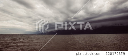 Cloudy storm in the sea before rainy.tornado storms cloud above the sea. Monsoon season. Storm in the sea.Wonder of natural disaster.Cloud before rain,Sky before the storm.use for background wallpaper 120179859