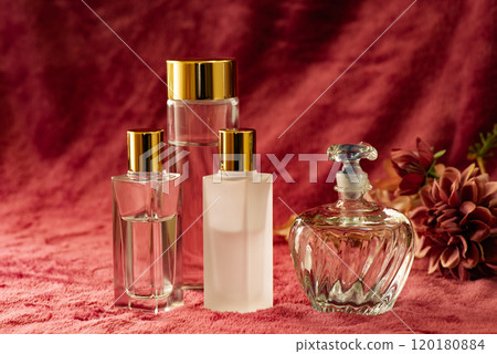 Red cloth and glass cosmetic and perfume bottles 120180884