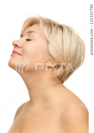 Side profile captures serene expression, with her glowing skin and soft smile hinting at balanced self-care routine and inner peace. 120181788