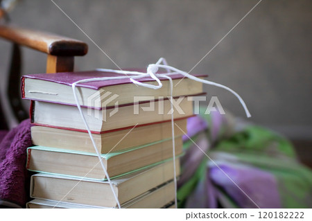 A neat stack of books that are tied together securely with a string A neat stack of books that are tied together securely with a string 120182222