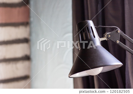A detailed close up view of a black lamp with an elegant white shade 120182505