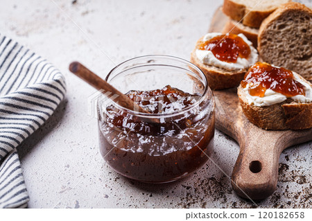 Onion jam on toast with cream cheese, gray background. 120182658