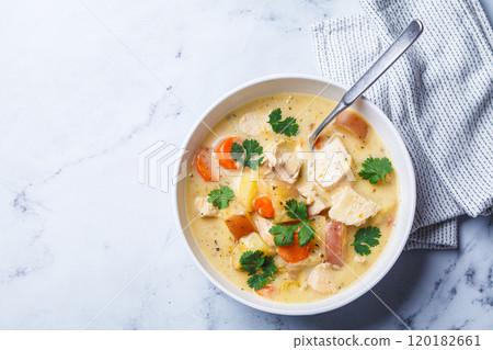 Chicken breast stew with potatoes and carrots in white bowl. Comfort food concept. Chicken breast stew with potatoes and carrots in white bowl. Comfort food concept. 120182661