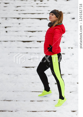 Woman wearing sportswear exercising during winter 120182718