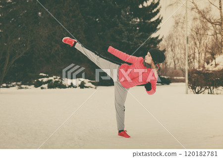 Woman wearing sportswear training boxing outside Woman wearing sportswear training boxing outside 120182781