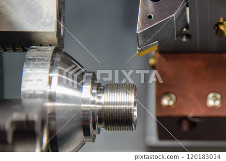 Close up scene the CNC lathe machine cutting the metal cone shape parts. Close up scene the CNC lathe machine cutting the metal cone shape parts. 120183014
