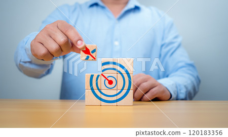 Businessman hands are completing wooden blocks with target sign. Startup concept. Business concept. Management concept. Business planning concept. Businessman hands are completing wooden blocks with target sign. Startup concept. Business concept. Management concept. Business planning concept. 120183356