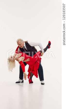 Tango aesthetic through years. Elderly beautiful woman and handsome senior man, couple dancing tango isolated on white background. Tango aesthetic through years. Elderly beautiful woman and handsome senior man, couple dancing tango isolated on white background. 120183507