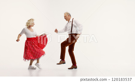 Elderly man and woman share joyful dance in retro-inspired outfits isolated on white background Elderly man and woman share joyful dance in retro-inspired outfits isolated on white background 120183537