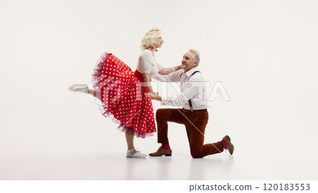 Elderly couple, dressed in vintage-inspired clothing, dances energetically retro dance isolated on white background 120183553