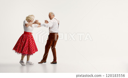 Elderly couple enjoying swing dancing, showcasing vibrant moves and joyful expressions, isolated on white background 120183556