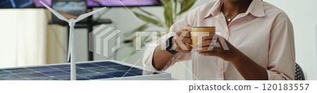 Woman Drinking Coffee In Office 120183557