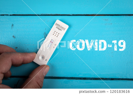 Covid-19. On a blue wooden table negative Covid test 120183616