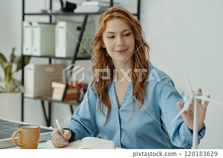 Woman Making Notes About New System Woman Making Notes About New System 120183629