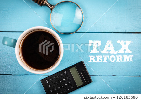 Tax Reform. Coffee mug, magnifying glass and calculator on a wooden background 120183680